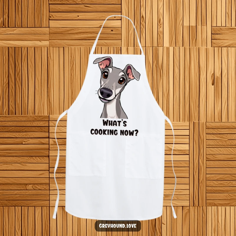 A greyhound tilting its head with wide, curious eyes is printed on a kitchen apron.