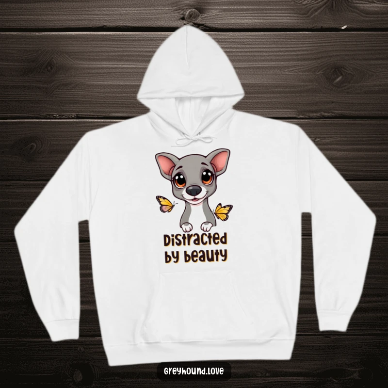 Funny Greyhound hoodie depicting a dog with large, happy eyes curiously watching a fluttering butterfly, offering warmth and whimsy.