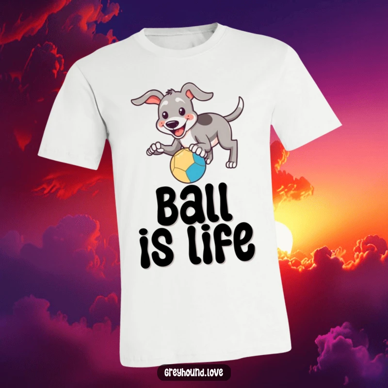 Funny T-Shirt: A smiling greyhound eagerly tries to catch a bouncing ball with its paws, looking playful.