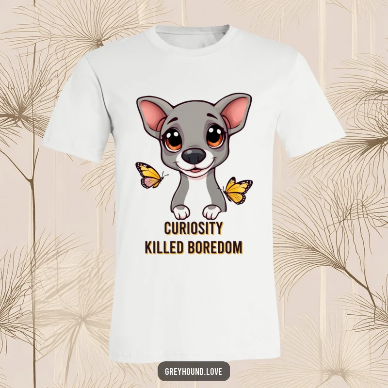 Funny Greyhound t-shirt featuring a dog with big, happy eyes looking curiously at a butterfly, highlighting gentle fascination.