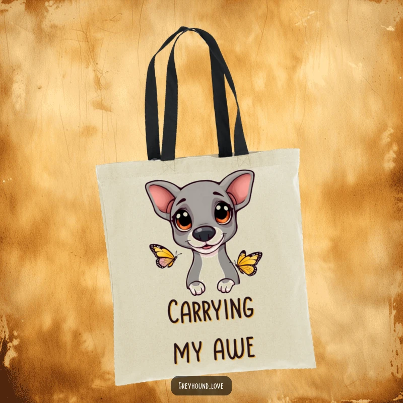 Funny Greyhound tote bag illustrating a dog with big, happy eyes curiously observing a butterfly, combining practicality and charm.