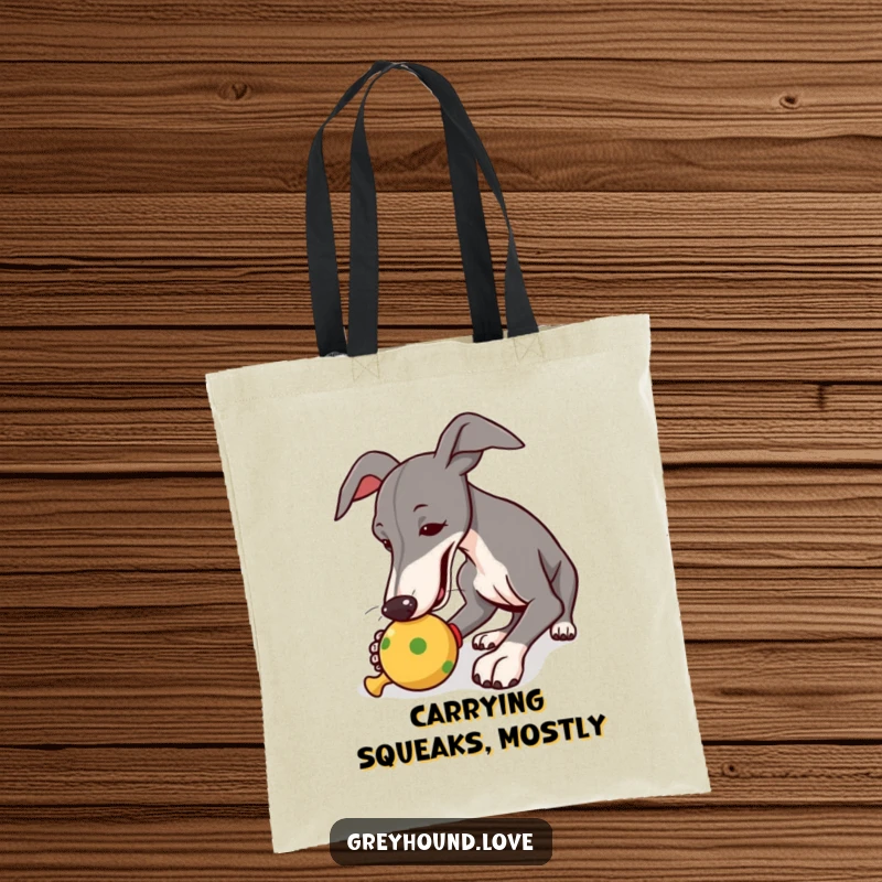 Funny tote bag capturing a greyhound in the act of joyfully nudging a squeaky toy, perfect for daily errands.
