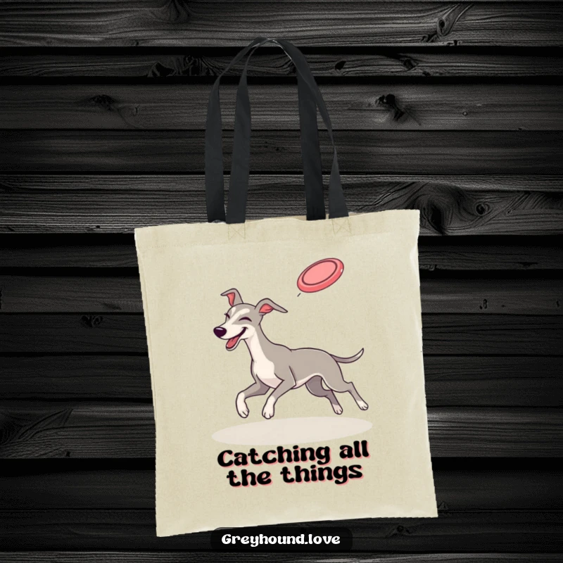 Funny TOTE BAG: A greyhound looks playful with a wink as it catches a flying frisbee mid-air. Perfect accessory.